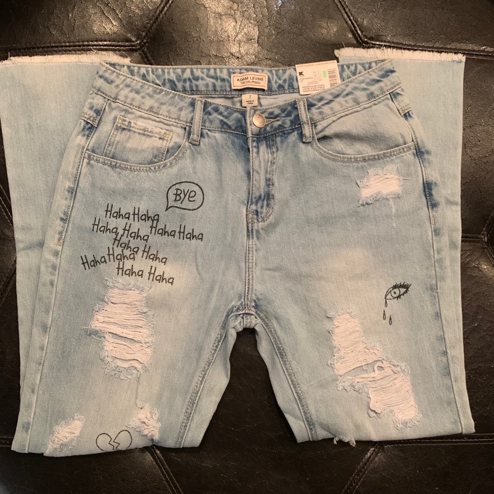 Ripped jeans with writing/doodles